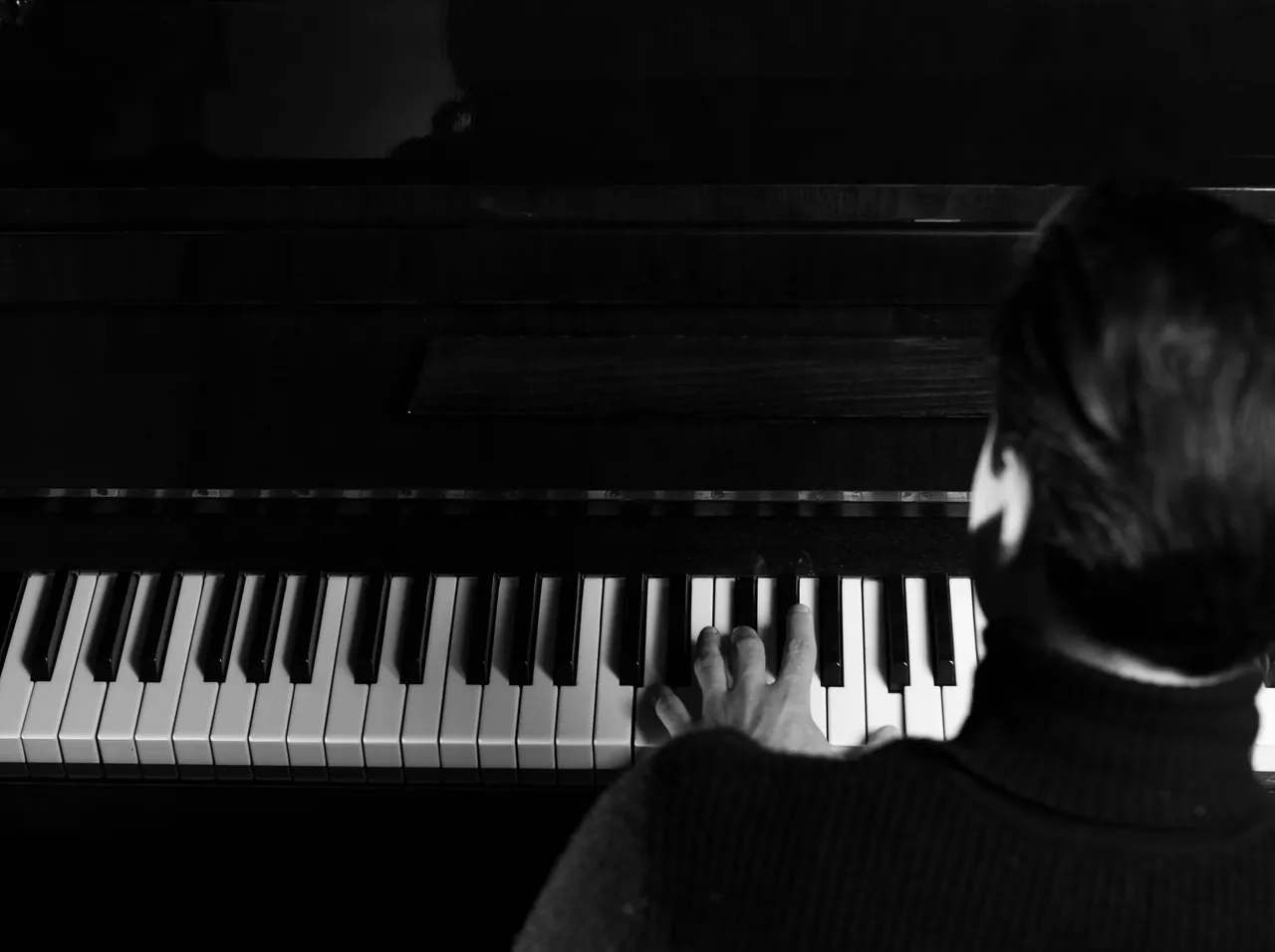 Christopher Nas at the piano, shot from above
